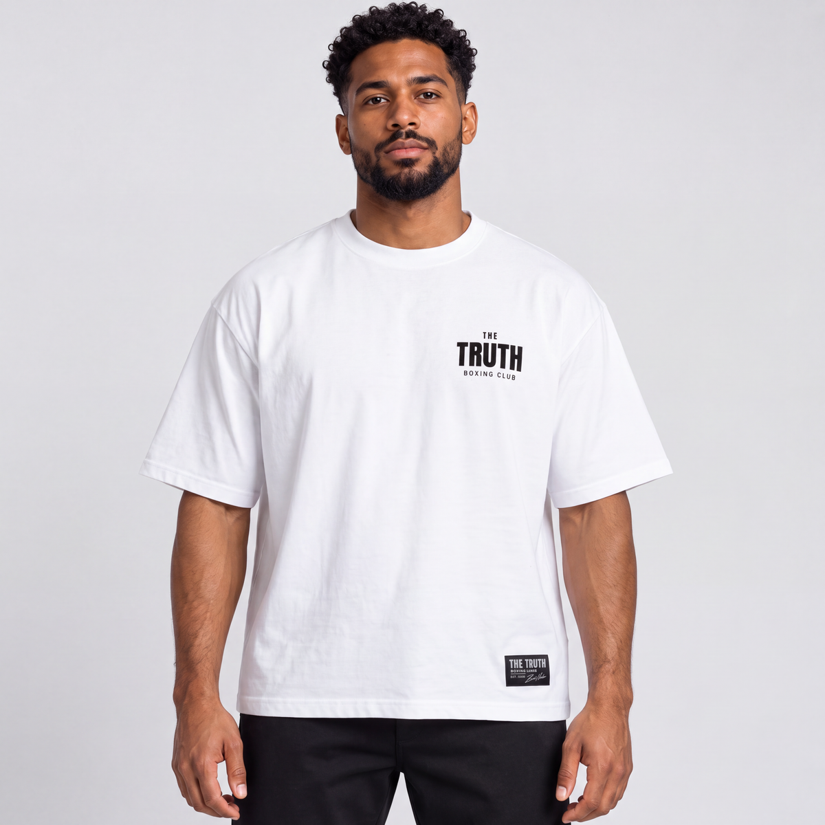 Front view of The Truth Boxing Club white tee with black chest logo and hem label.