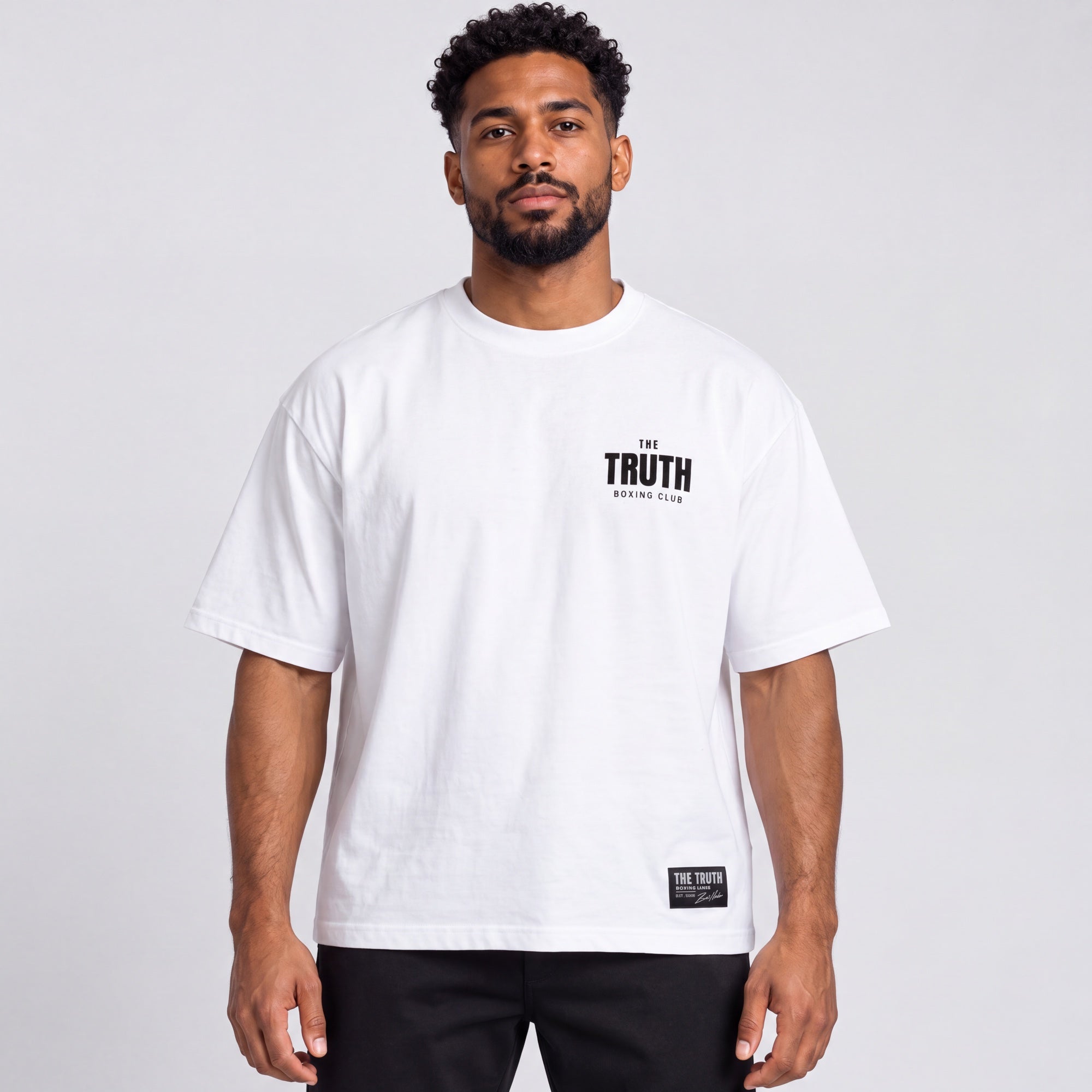 Front of the white Club Logo Tee with black chest logo and hem label